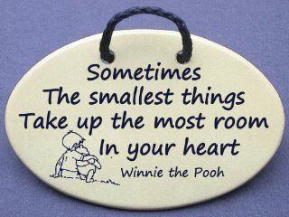 Sometimes the smallest things take up the most room in your heart: Christopher Robin speaking to Winnie the Pooh. Mountain Meadows ceramic plaques and wall signs with sayings and quotes about love, babies, and pets. Made by Mountain Meadows in the USA.   H
